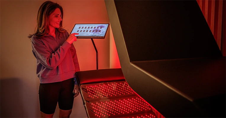 Chiropractic Madison AL Red Light Therapy Woman With Computer